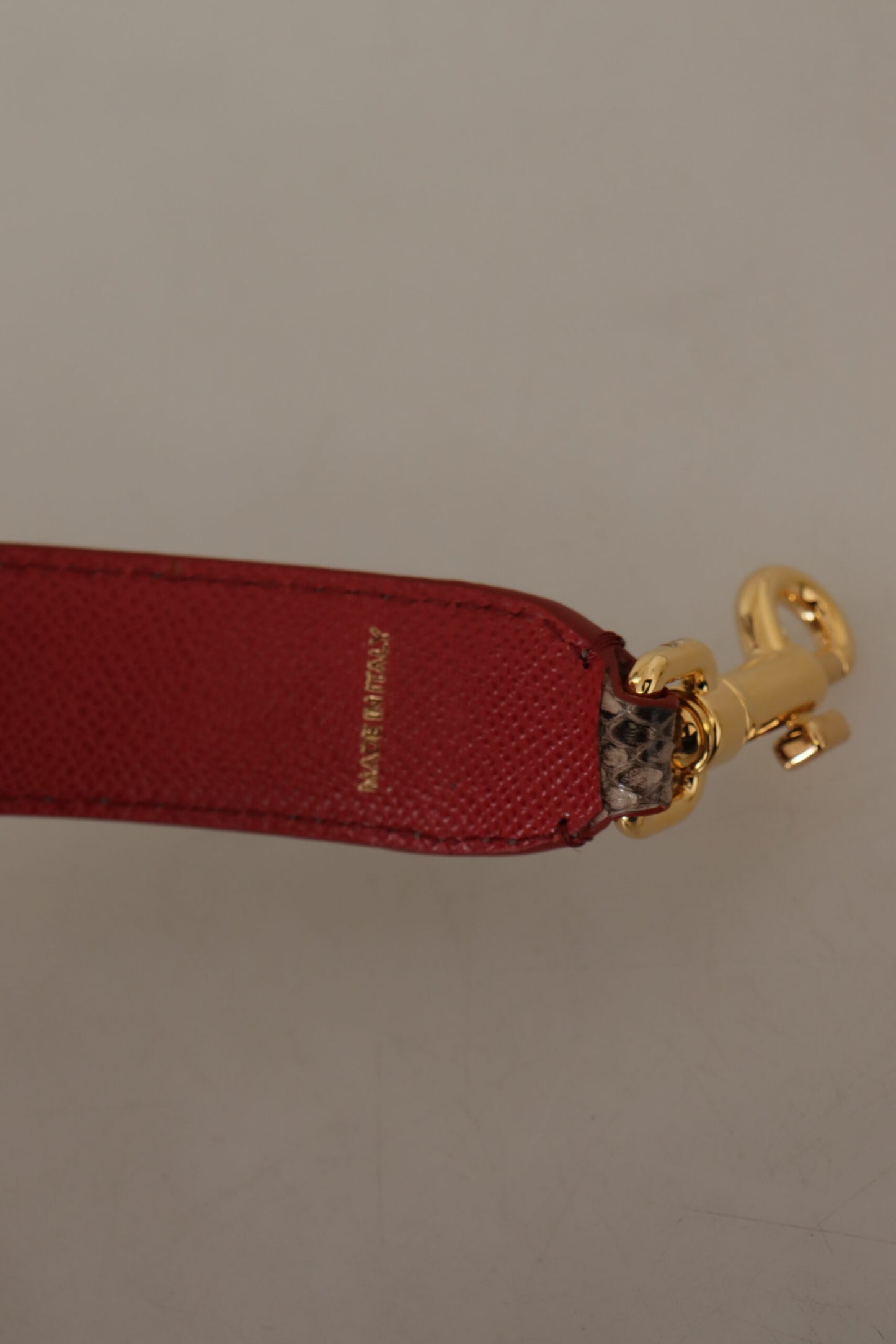 حزام كتف من الجلد المصنوع من جلد الأفعى البني من Dolce & Gabbana مزين بالدبابيس.